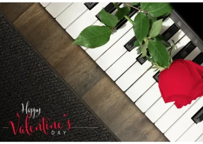 Happy Valentine`s Day Card Design with Romantic Red Rose on Piano Keyboard